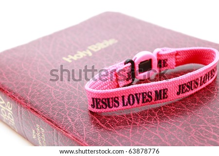 Jesus Loves the Bible A bible with a Jesus Loves Me wristband. Horizontal.
