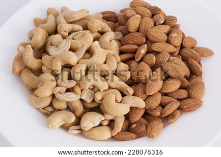 assorted cashews and almonds on white background