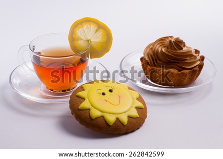 Delicious hot tea with cake and biscuit.
