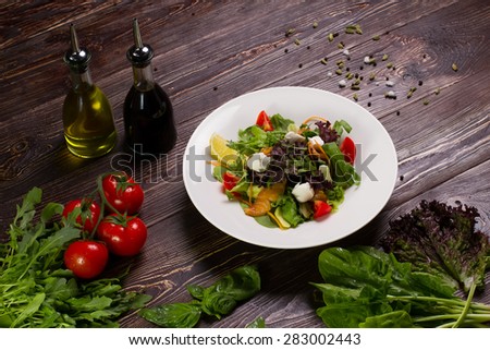 Delicious salad with salmon fillet, aromatic herbs, spices and vegetables. Healthy food, diet or cooking concept.