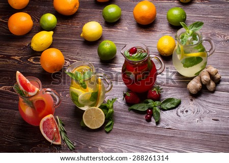 Summer drinks with ice, fresh berries and citrus fruits. Different types of fresh lemonades.