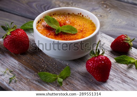 Italian dessert. Delicious cream brulee with strawberries and mint.