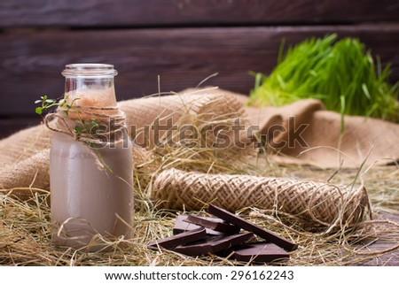 Natural chocolate milkshake with pieces of chocolate  in the hay.