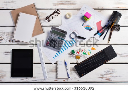 Workplace. Office stationery. Office life. Stationery and gadgets on a wooden background.