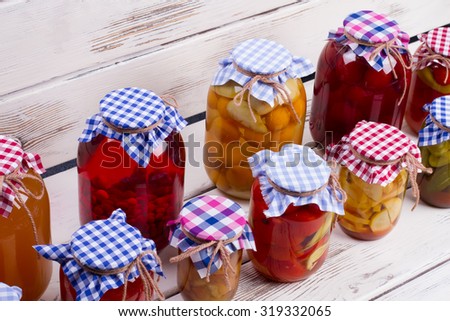 Glass jars with preservation stand on old boards. Harvest of food products.