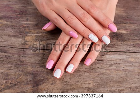 White-pink manicure on old retro background. Salon of nail aesthetics.