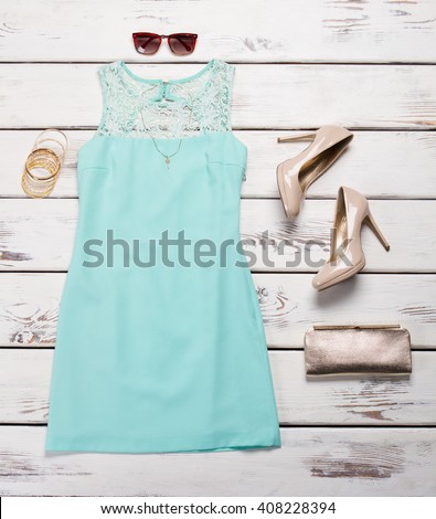 Blue dress and heel shoes. Shelf with dress and footwear. Lace insert dress with accessories. Luxury outfit for young ladies.