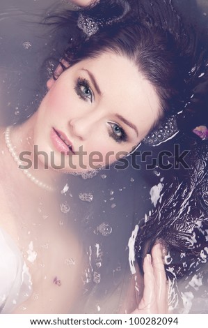 A beautiful brunette submerged in water