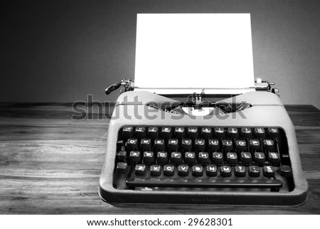 A black and white image of an old typewriter. Space for text.