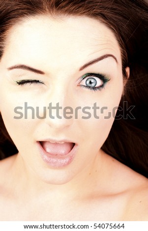 A close up of a pretty young woman pulling a silly face.