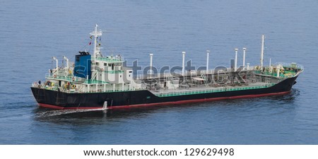 A medium sized chemical/liquid transport ship cruises across the bay.