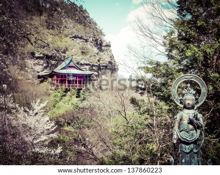 Vintage style photo - A temple on the side of the cliff, 1000 steps up a mountain.