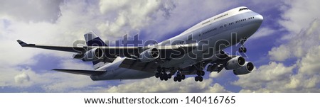 Large modern 4 engine airliner banner on a mainly cloudy sky background.