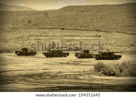 Grunge style image of modern armored tanks in battle