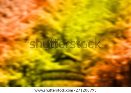 (BLUR style Abstract background) Autumn leaves behind a Buddha statue. Tokyo.