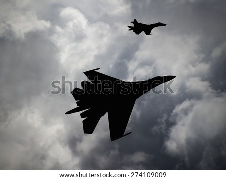 (Computer illustration) Silhouette or modern, Russian made, 4th generation, pair of Su-27 Flanker against a cloudy sky.