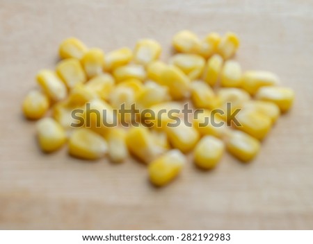 blur canned corn on wooden Cutting Board
