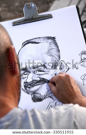 BARCELONA, SPAIN - SEPTEMBER 11, 2015: The rambla street in Barcelona is popular for their artist like the caricaturist drawing people with different styles.