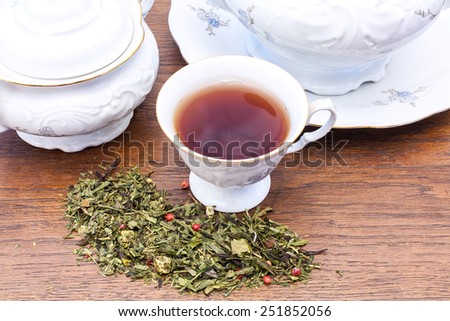 Elegant china with tea and tea leaves.