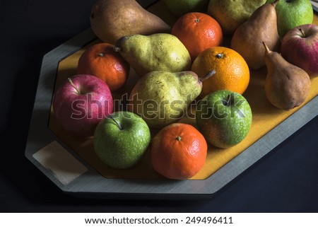 fruit on the tray, various fruits from the garden on the tray, apple, pear, orange,mandarin . natural light