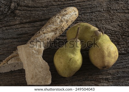 three pears with parmesan cheese and spiced bread,three pears with parmesan cheese and spicy bread laid on the old table