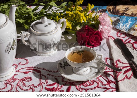 hour the tea, morning or afternoon , table with a cup of tea with flowers, romance novel, romantic afternoon
