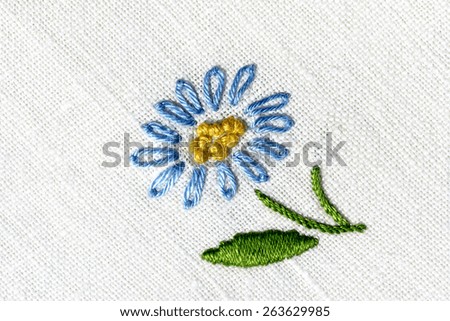 cotton fabric embroidered with flowers , cotton fabric embroidered  to crochet with colorful flowers ,white background, photo from above