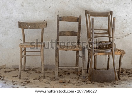 old wooden chairs on white background,dust and cobwebs on the chairs natural light, front view