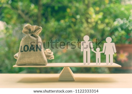 Family finance / financial loan and risk management concept : Loan bags, white acrylic cut (dad, mom, son) on basic balance scale, depicts loan between family members, not use a bank or credit union.