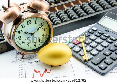 Golden egg and a golden key with a clock on business and financial reports : Key success in sustainable growth investment concept