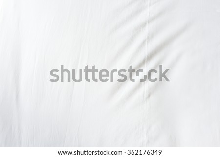Top view of wrinkles on an unmade  bed sheet after waking up in the morning.