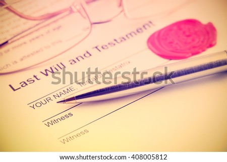 Vintage / retro style : Last will and testament sealed with wax seal, stamped / embossed with alphabet letter B. With a blue ballpoint pen and eye glasses on a table.