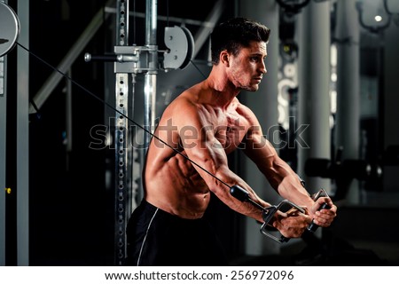 handsome bodybuilder works out  pushing up excercise in gym