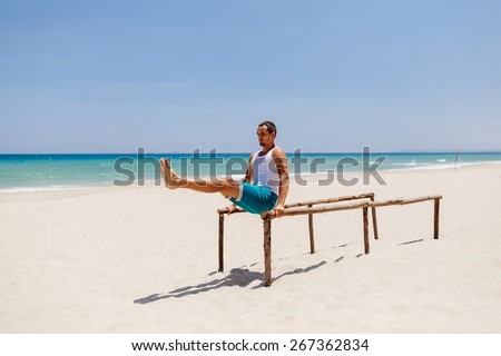 fitness handsome man work out on the beach with sea view