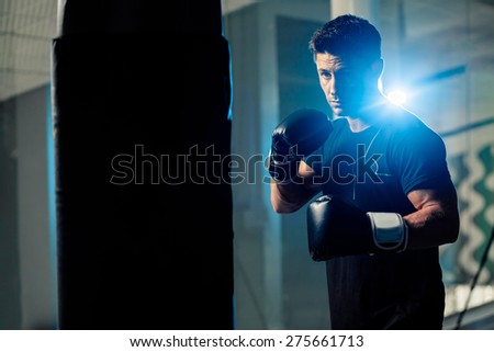 muscular handsome boxing man fighter with boxing bag