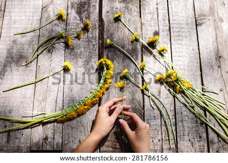 wreath of dandelions flowers handmade handicraft with flowers on vintage wood table