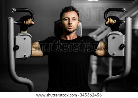 handsome bodybuilder man works out  pushing up excercise in gym