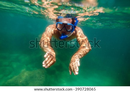snorkeling man swim underwater in turquoise sea