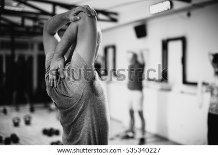 crossfit group training. Man and woman group training indoors. Black and white