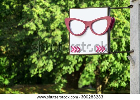 Blank optics glasses advertising sign on a building wall
