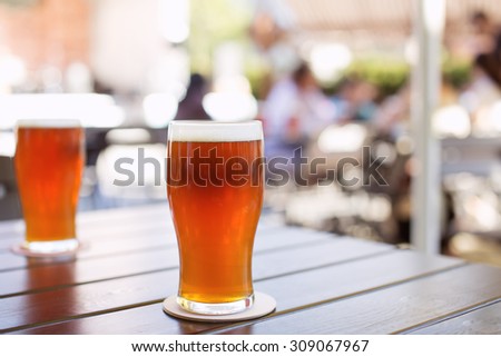 Glass of craft IPA beer on a table during beer festival in Belarus. India pale ale hoppy beer