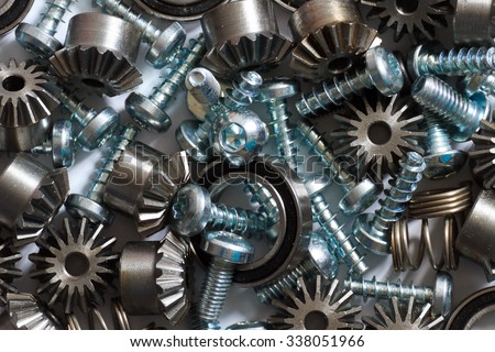 A background with different mechanical components, gears, springs, screws, industrial objects