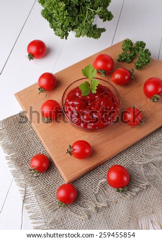 tomato paste on wooden board with tomatoes