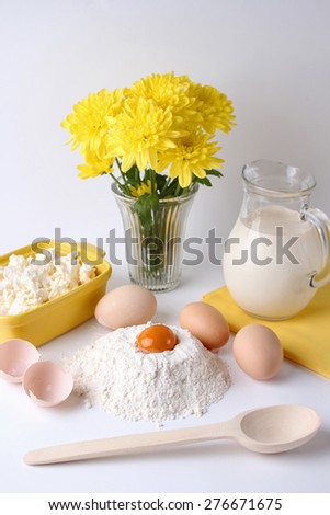 egg, milk, flour on a white background