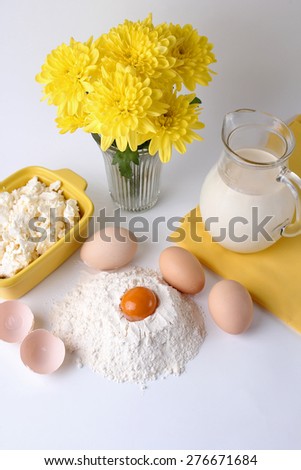 egg, milk, flour on a white background