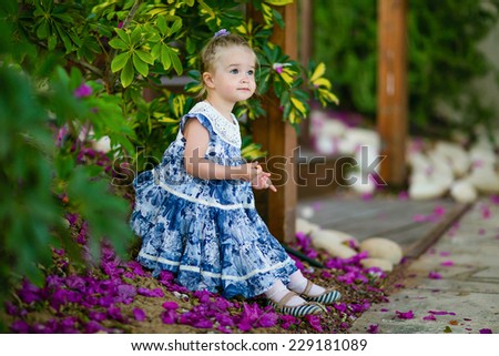 Very cute little girl in a blue dress