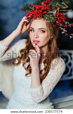 portrait of red-haired girl with a wreath of red berries on the head
