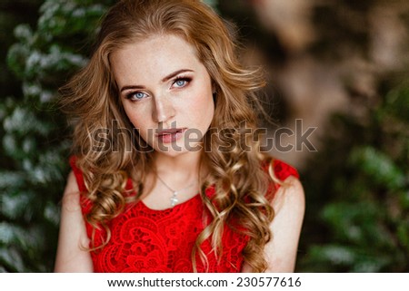 Portrait of a red haired girl in red dress