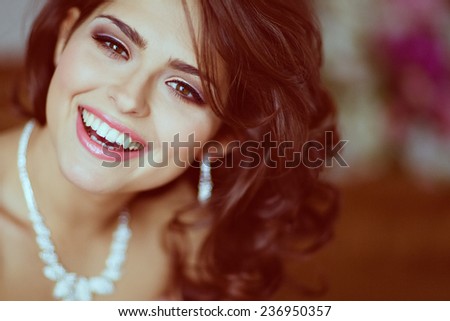 Very beautiful brunette girl with brown eyes smiling and happy, close up