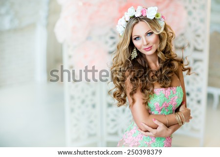 Very beautiful and sensual blonde girl in a lace dress with a wreath of flowers on his head, close up